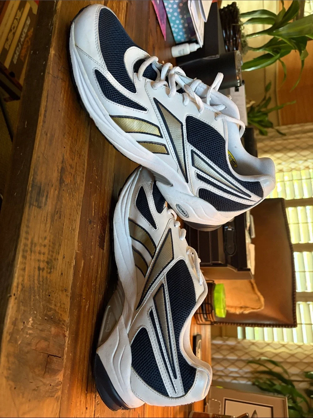 Like New Reebok size 10.5 Men's White and Navy Athletic Sneakers with Gold Accen